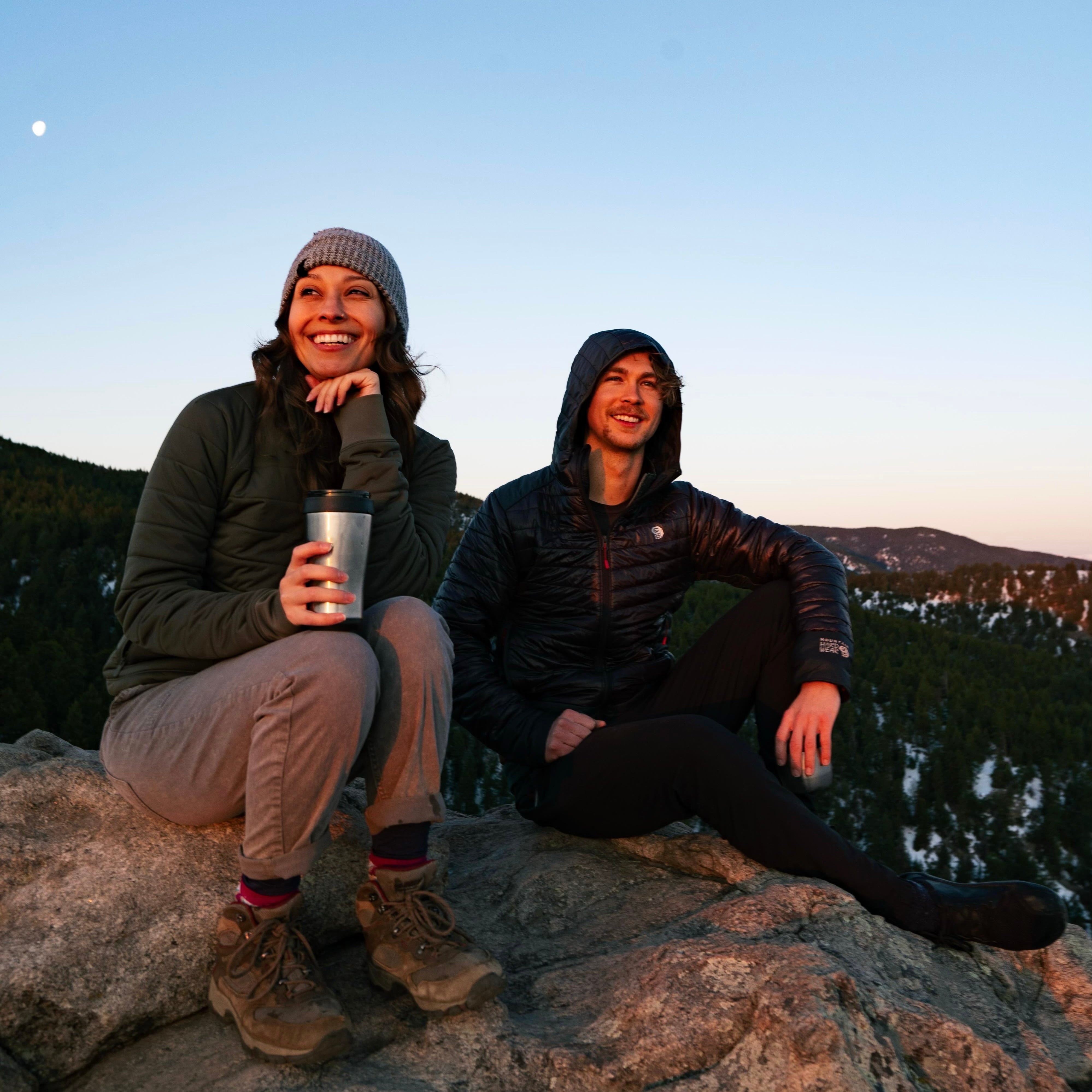 Jimbo & Jules sitting on a rock on top of a mountain