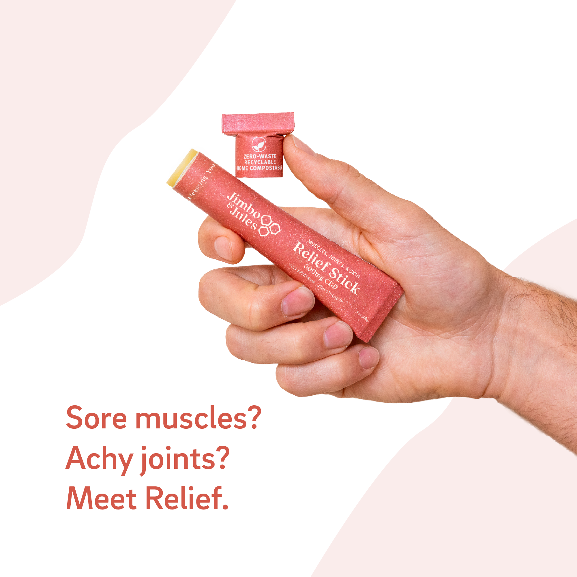 Hand holding a red pain relief stick with text about sore muscles and achy joints on a light background